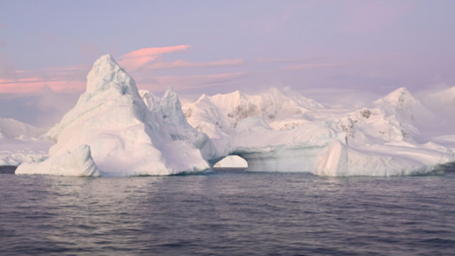 An arched iceberg along the Antarctic Peninsula, taken June 17, 2022. Last month Antarctic sea ice extent reached a record low for June, at 4.68 million square miles — or about 471,000 square miles below average. (Dan Costa/National Science Foundation/Creative Commons: https://creativecommons.org/licenses/by-nc-nd/4.0/)